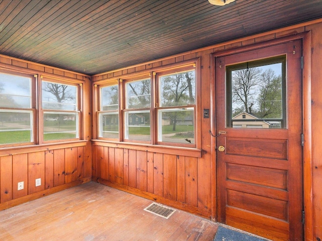 unfurnished sunroom with visible vents