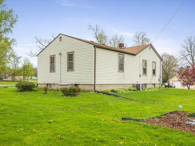 view of side of property featuring central AC unit, a chimney, and a lawn