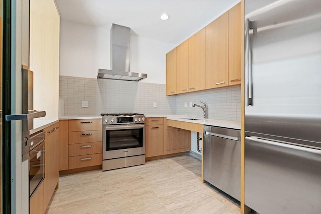 kitchen featuring appliances with stainless steel finishes, range hood, a sink, light countertops, and tasteful backsplash