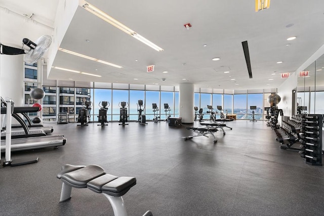 gym featuring expansive windows, healthy amount of natural light, and recessed lighting