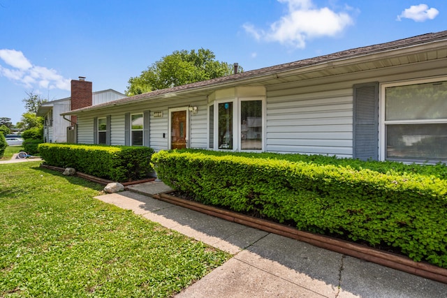 2503 Maplewood Dr, Champaign, IL 61821 - single story home featuring a front lawn and a chimney