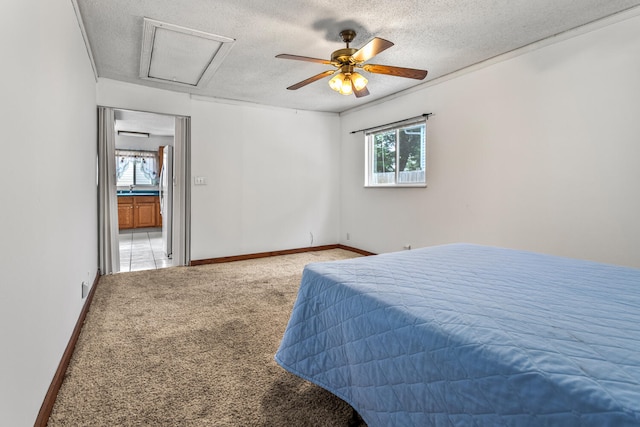 2503 Maplewood Dr, Champaign, IL 61821 - carpeted bedroom featuring a textured ceiling, attic access, ceiling fan, baseboards, and freestanding refrigerator