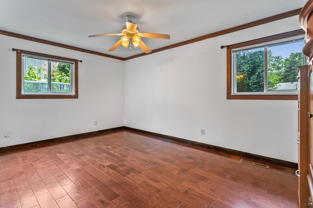 2503 Maplewood Dr, Champaign, IL 61821 - spare room featuring healthy amount of natural light, baseboards, a ceiling fan, wood finished floors, and ornamental molding