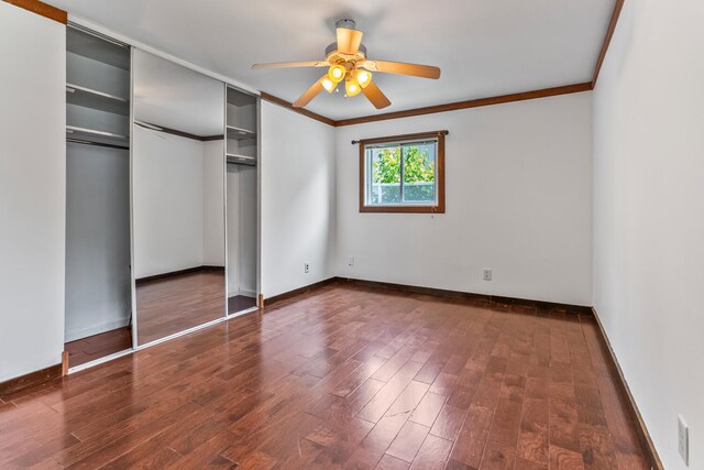 2503 Maplewood Dr, Champaign, IL 61821 - unfurnished bedroom with crown molding, wood finished floors, a closet, baseboards, and ceiling fan