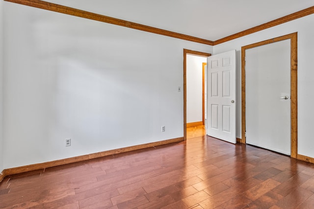 2503 Maplewood Dr, Champaign, IL 61821 - spare room featuring baseboards, wood finished floors, and crown molding