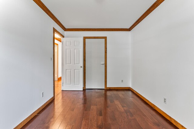 2503 Maplewood Dr, Champaign, IL 61821 - unfurnished room with crown molding, dark wood-style flooring, and baseboards