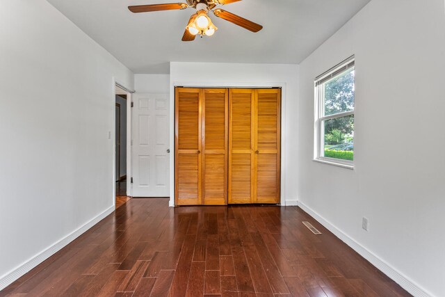 2503 Maplewood Dr, Champaign, IL 61821 - unfurnished bedroom with wood finished floors, a closet, baseboards, and ceiling fan