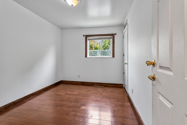 2503 Maplewood Dr, Champaign, IL 61821 - spare room featuring dark wood finished floors and baseboards