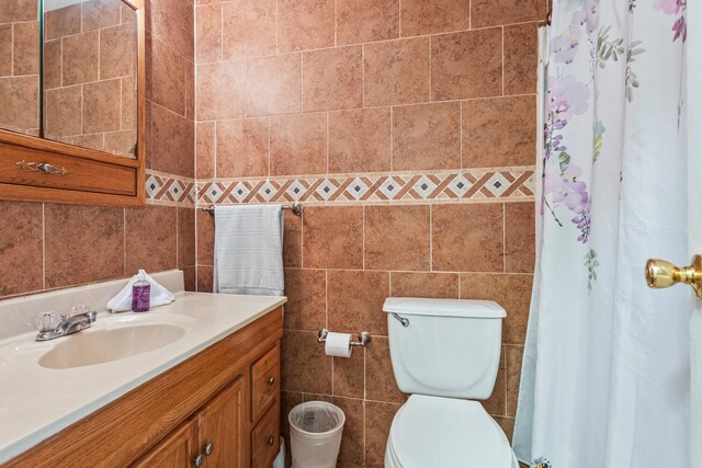 2503 Maplewood Dr, Champaign, IL 61821 - full bathroom with tile walls, vanity, toilet, and a shower with curtain