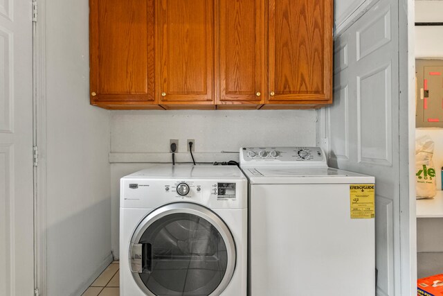 2503 Maplewood Dr, Champaign, IL 61821 - laundry area featuring cabinet space, separate washer and dryer, electric panel, and tile patterned flooring