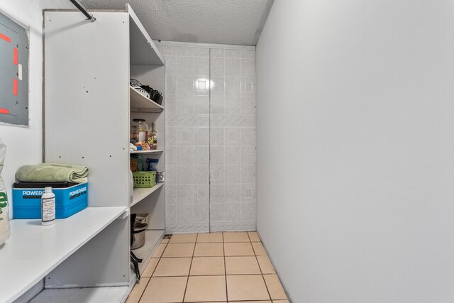 2503 Maplewood Dr, Champaign, IL 61821 - bathroom with tile patterned flooring, a textured ceiling, and electric panel