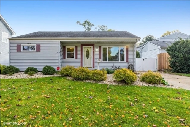 single story home featuring a front yard and fence