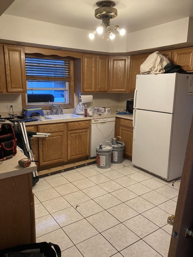 303 N School St, Mount Prospect, IL 60056 - kitchen with white appliances, light tile patterned floors, a sink, brown cabinets, and light countertops