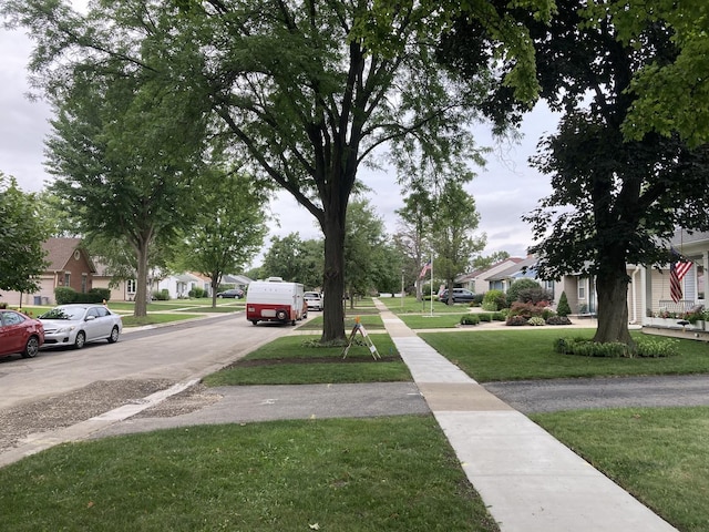 view of street with a residential view, curbs, and sidewalks
