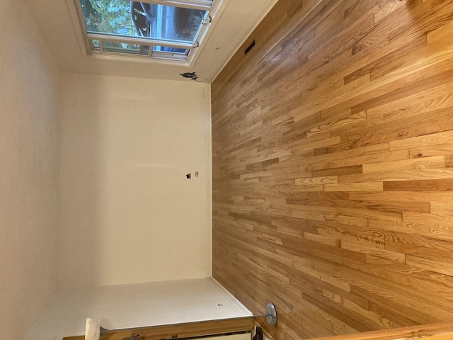mudroom with wood walls