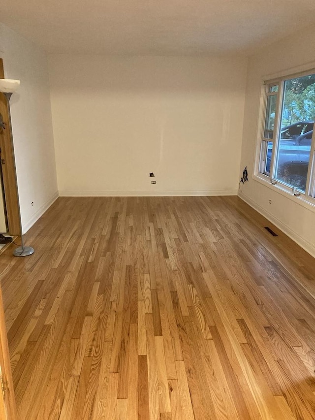 303 N School St, Mount Prospect, IL 60056 - spare room featuring light wood-style floors and baseboards