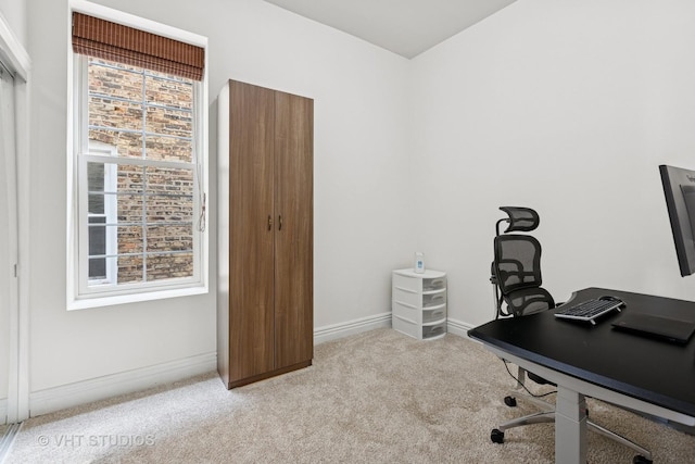 carpeted home office featuring baseboards