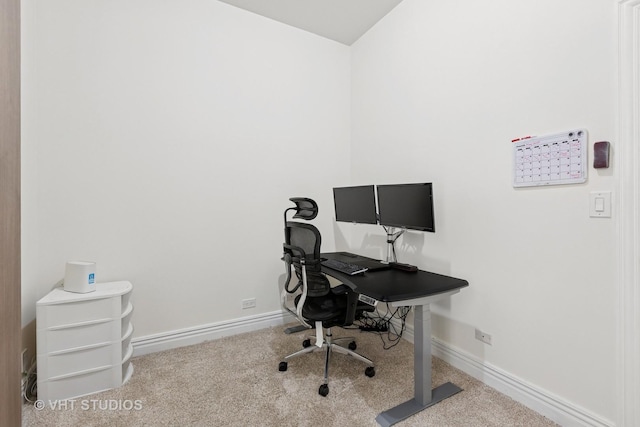 carpeted office featuring baseboards