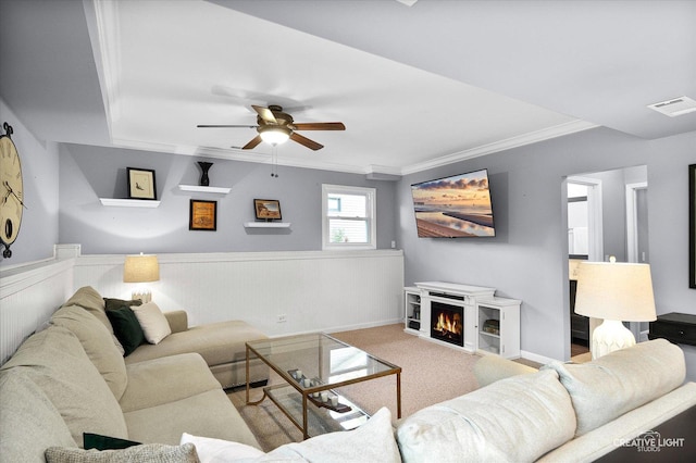 1316 Carol Ln, Naperville, IL 60565 - living room featuring ornamental molding, a ceiling fan, a wainscoted wall, carpet floors, and a lit fireplace