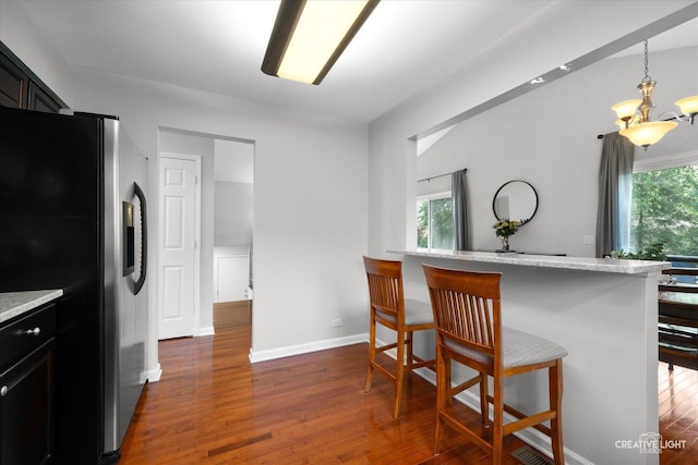 1316 Carol Ln, Naperville, IL 60565 - kitchen featuring stainless steel refrigerator with ice dispenser, dark wood finished floors, a kitchen breakfast bar, and a chandelier