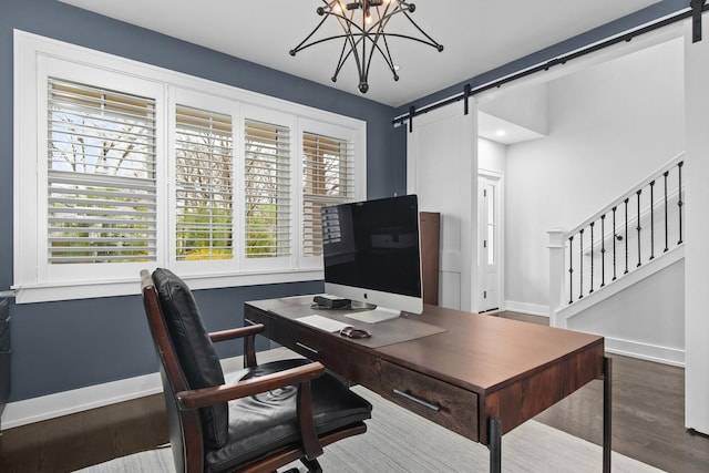 15 Reliance Ln, Lincolnshire, IL 60069 - office with baseboards, a barn door, wood finished floors, and a chandelier