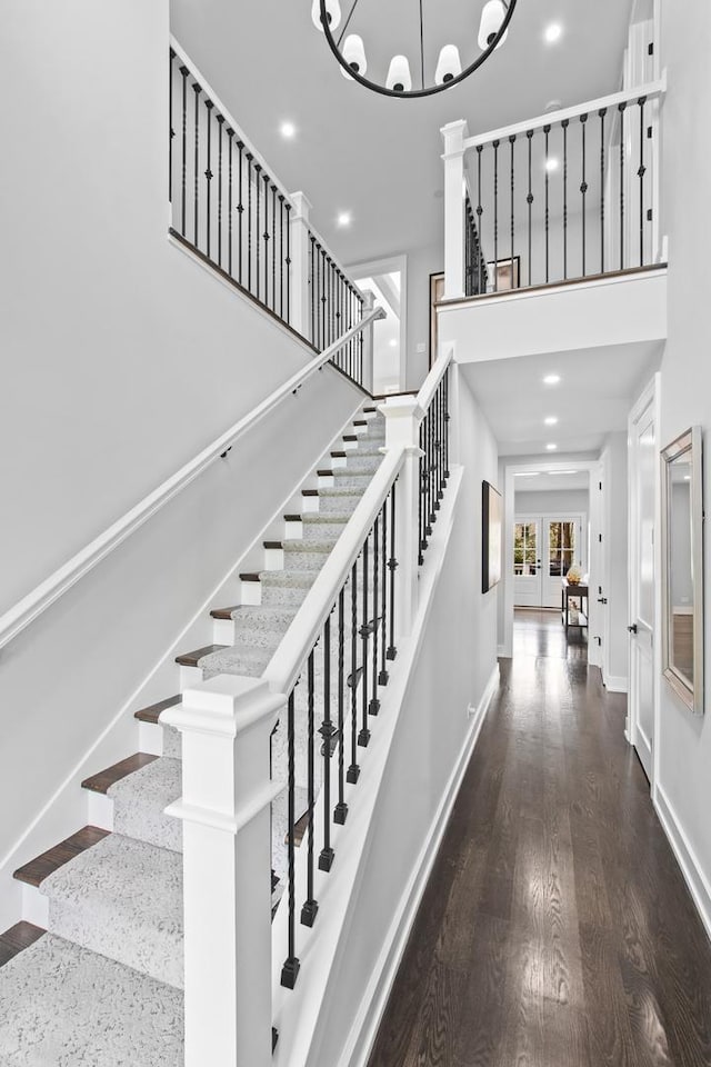15 Reliance Ln, Lincolnshire, IL 60069 - stairs featuring a high ceiling, wood finished floors, baseboards, recessed lighting, and a chandelier