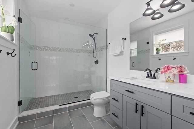 15 Reliance Ln, Lincolnshire, IL 60069 - bathroom featuring toilet, tile patterned floors, a shower stall, and vanity