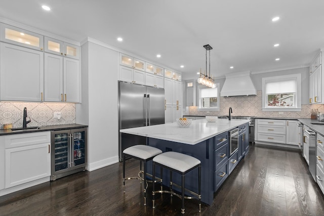 15 Reliance Ln, Lincolnshire, IL 60069 - kitchen with a sink, wine cooler, premium range hood, white cabinets, and dark wood-type flooring