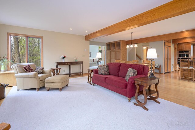 living area with light wood-style flooring and recessed lighting