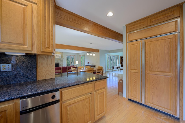 kitchen with paneled fridge, tasteful backsplash, light wood finished floors, recessed lighting, and beam ceiling