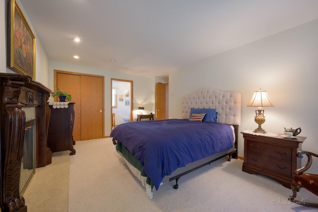 carpeted bedroom with recessed lighting and ensuite bath