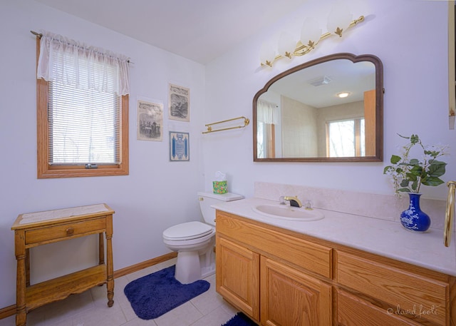 bathroom featuring toilet, vanity, and tile patterned floors