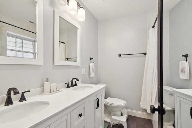 full bathroom with toilet, double vanity, baseboards, marble look tile flooring, and a shower with shower curtain