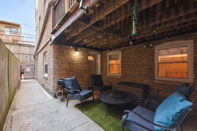 view of patio featuring fence and an outdoor fire pit