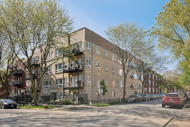 view of apartment building / complex featuring fence