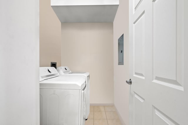 laundry area with independent washer and dryer, light tile patterned floors, baseboards, electric panel, and laundry area