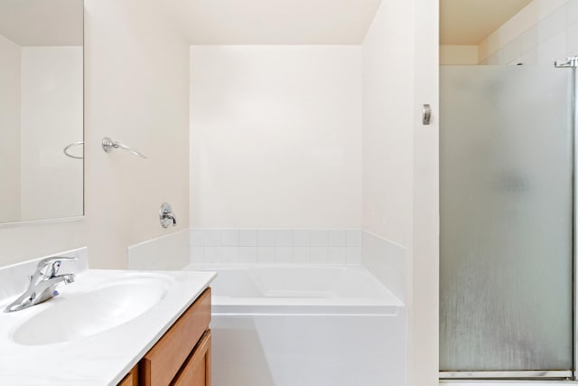 full bath with vanity, a shower stall, and a bath