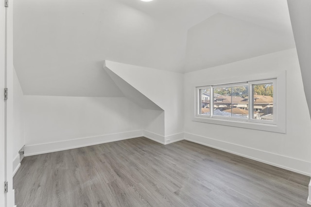 7732 W Sunset Dr, Elmwood Park, IL 60707 - bonus room featuring lofted ceiling, baseboards, and wood finished floors