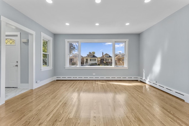 7732 W Sunset Dr, Elmwood Park, IL 60707 - spare room with a wealth of natural light, baseboard heating, and recessed lighting