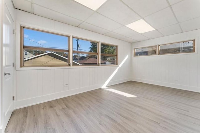 7732 W Sunset Dr, Elmwood Park, IL 60707 - unfurnished room featuring a drop ceiling, wood finished floors, and baseboards