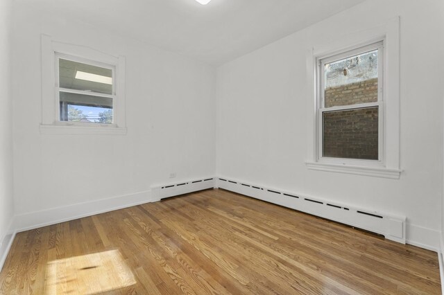 7732 W Sunset Dr, Elmwood Park, IL 60707 - spare room featuring light wood-style flooring, baseboards, and baseboard heating