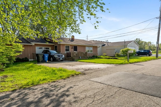 165 Ross Ave, South Elgin, IL 60177 - single story home featuring driveway, a garage, board and batten siding, and a front lawn