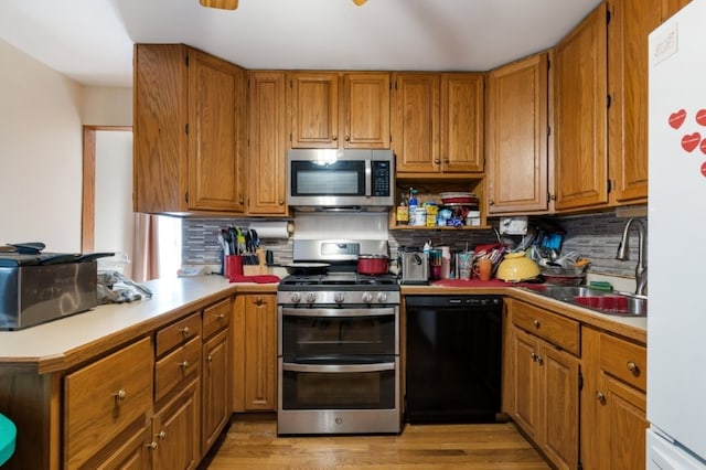 165 Ross Ave, South Elgin, IL 60177 - kitchen with stainless steel appliances, a sink, decorative backsplash, and brown cabinets