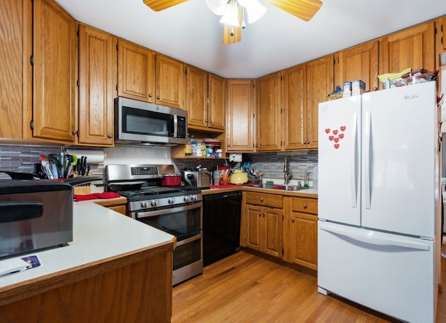 165 Ross Ave, South Elgin, IL 60177 - kitchen with stainless steel appliances, brown cabinets, light wood finished floors, and a sink
