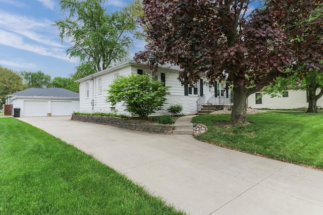 704 S Cottage Ave, Normal, IL 61761 - view of property hidden behind natural elements featuring a garage, an outbuilding, and a front yard