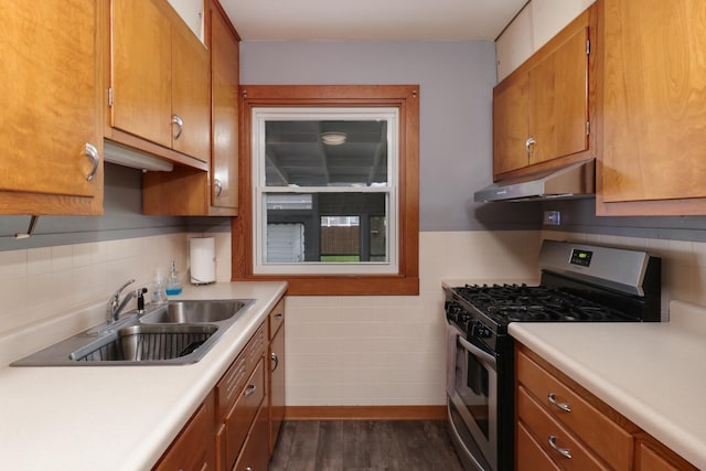 704 S Cottage Ave, Normal, IL 61761 - kitchen featuring gas stove, under cabinet range hood, dark wood-type flooring, light countertops, and a sink