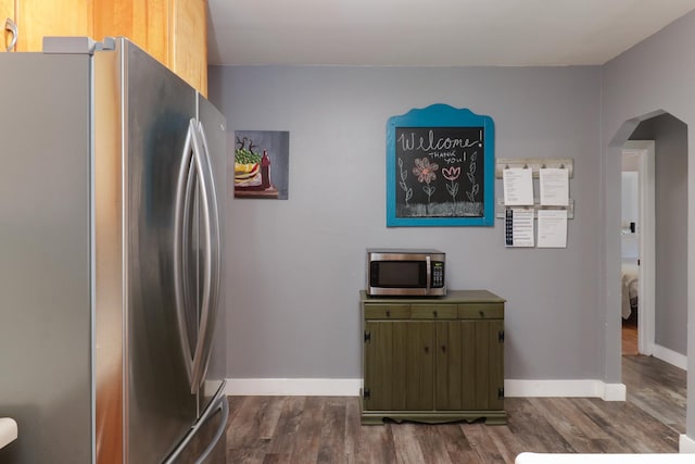 704 S Cottage Ave, Normal, IL 61761 - kitchen with appliances with stainless steel finishes, arched walkways, dark wood finished floors, and baseboards
