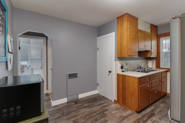 704 S Cottage Ave, Normal, IL 61761 - kitchen with freestanding refrigerator, dark wood-style flooring, a sink, light countertops, and decorative backsplash