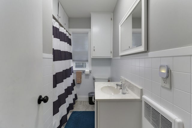 704 S Cottage Ave, Normal, IL 61761 - bathroom with tile walls, vanity, a shower with shower curtain, toilet, and a wainscoted wall