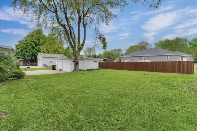 704 S Cottage Ave, Normal, IL 61761 - view of yard with a garage, concrete driveway, and an outbuilding